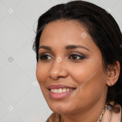 Joyful black young-adult female with long  black hair and brown eyes