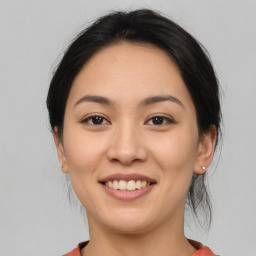 Joyful asian young-adult female with medium  brown hair and brown eyes