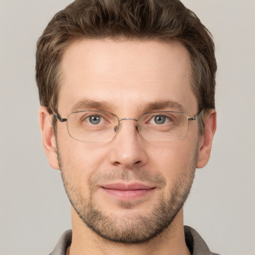 Joyful white adult male with short  brown hair and grey eyes