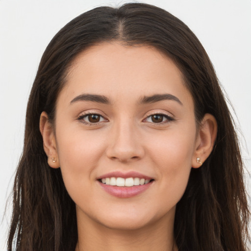 Joyful white young-adult female with long  brown hair and brown eyes