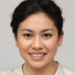 Joyful latino young-adult female with short  brown hair and brown eyes