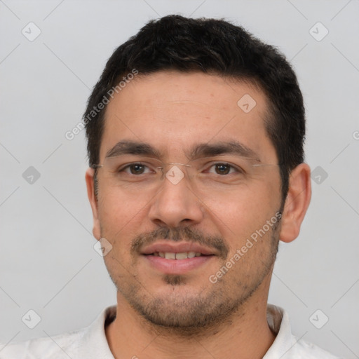 Joyful white young-adult male with short  black hair and brown eyes