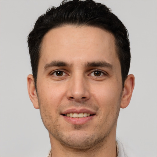 Joyful white young-adult male with short  brown hair and brown eyes