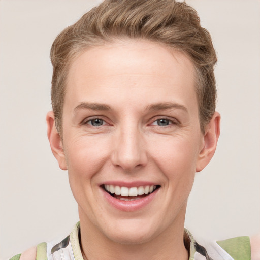 Joyful white young-adult female with short  brown hair and grey eyes