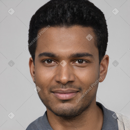 Joyful black young-adult male with short  black hair and brown eyes