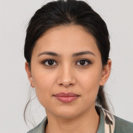 Joyful latino young-adult female with medium  brown hair and brown eyes