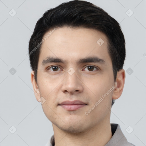 Joyful white young-adult male with short  black hair and brown eyes