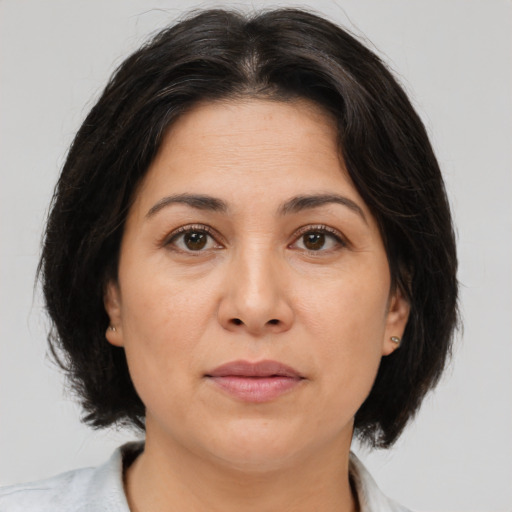 Joyful white adult female with medium  brown hair and brown eyes
