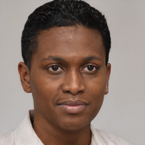 Joyful black young-adult male with short  brown hair and brown eyes