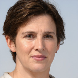 Joyful white adult female with short  brown hair and grey eyes