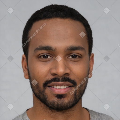 Joyful black young-adult male with short  black hair and brown eyes