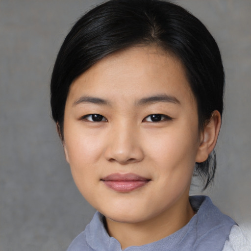 Joyful asian young-adult female with medium  black hair and brown eyes