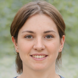 Joyful white young-adult female with medium  brown hair and brown eyes