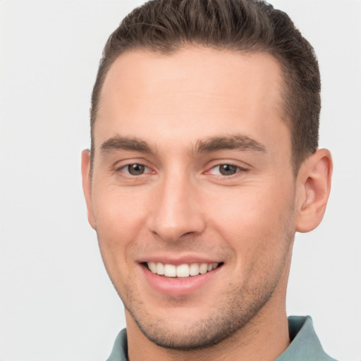 Joyful white young-adult male with short  brown hair and brown eyes