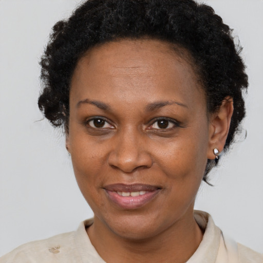 Joyful black adult female with short  brown hair and brown eyes