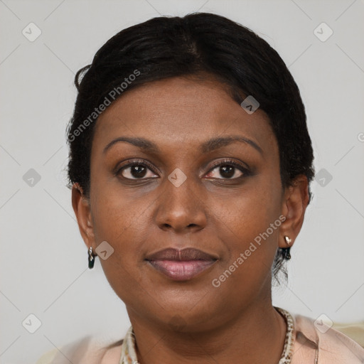 Joyful black young-adult female with short  brown hair and brown eyes