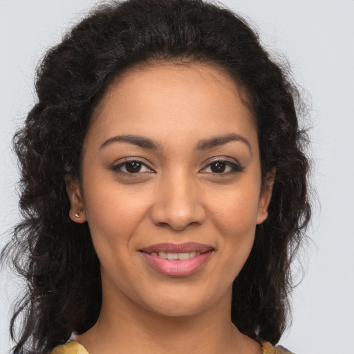 Joyful latino young-adult female with long  brown hair and brown eyes