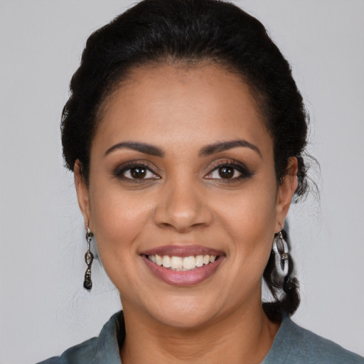 Joyful latino young-adult female with long  black hair and brown eyes