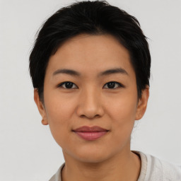 Joyful asian young-adult female with short  black hair and brown eyes