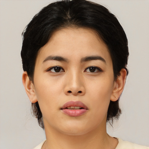 Joyful asian young-adult female with medium  black hair and brown eyes