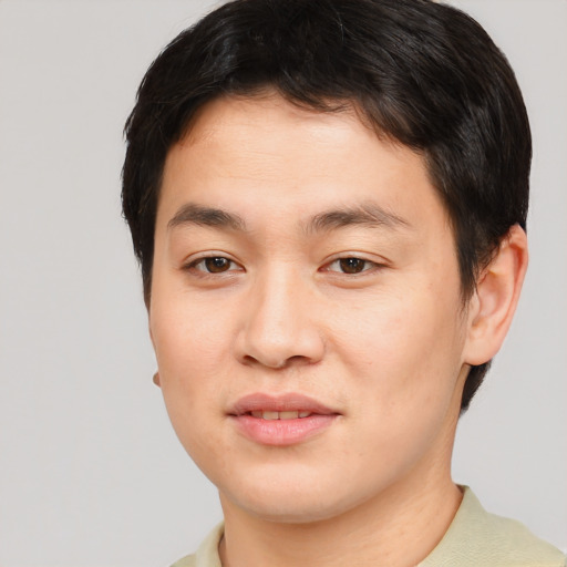 Joyful asian young-adult male with short  brown hair and brown eyes