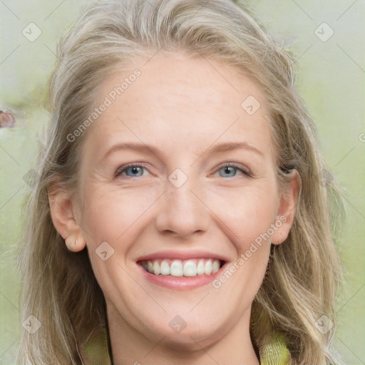 Joyful white young-adult female with long  blond hair and blue eyes