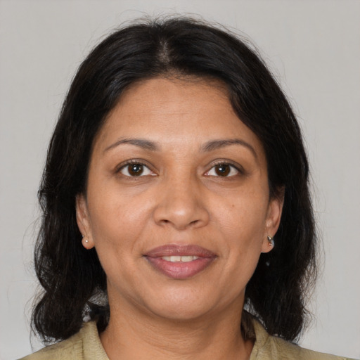 Joyful black adult female with medium  brown hair and brown eyes