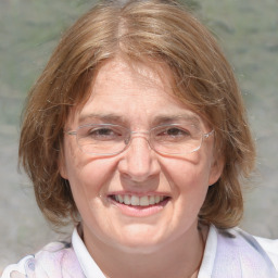 Joyful white adult female with medium  brown hair and blue eyes