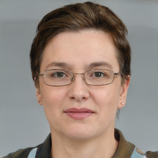 Joyful white adult female with short  brown hair and grey eyes