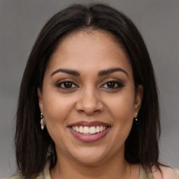 Joyful latino young-adult female with medium  brown hair and brown eyes