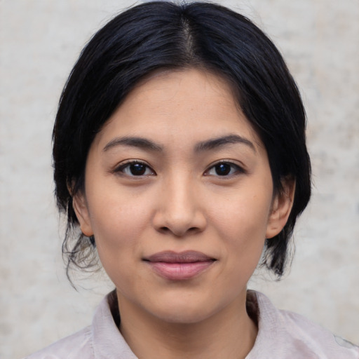Joyful latino young-adult female with medium  black hair and brown eyes