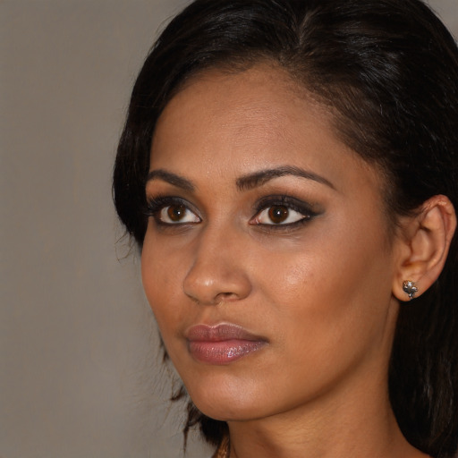 Neutral black young-adult female with long  brown hair and brown eyes