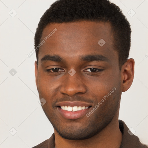 Joyful black young-adult male with short  brown hair and brown eyes