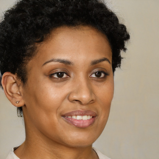 Joyful black young-adult female with short  brown hair and brown eyes