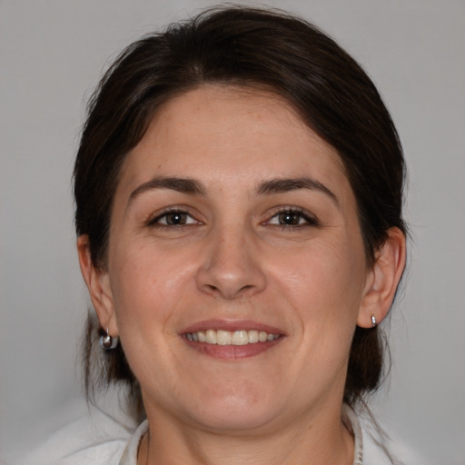 Joyful white young-adult female with medium  brown hair and brown eyes