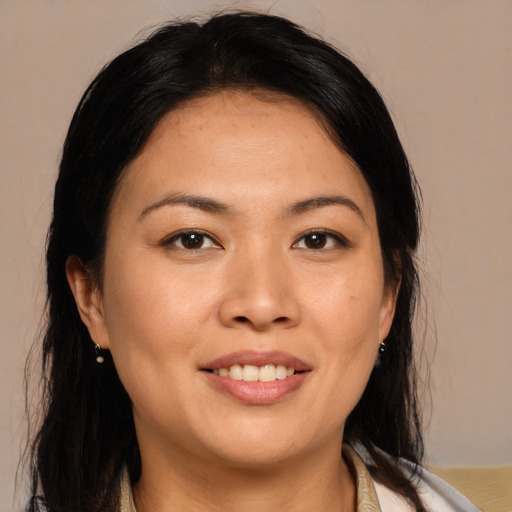 Joyful asian young-adult female with long  brown hair and brown eyes