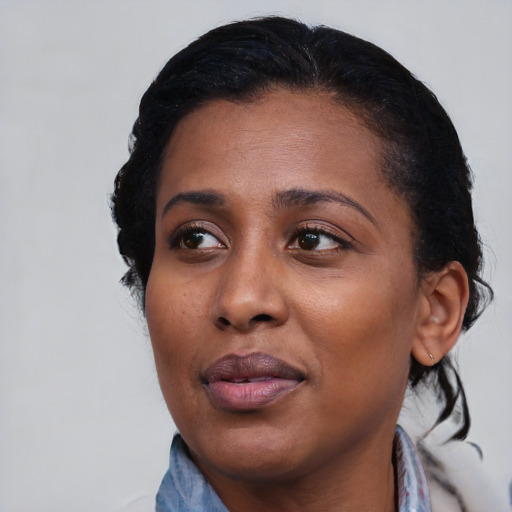 Joyful black adult female with medium  black hair and brown eyes