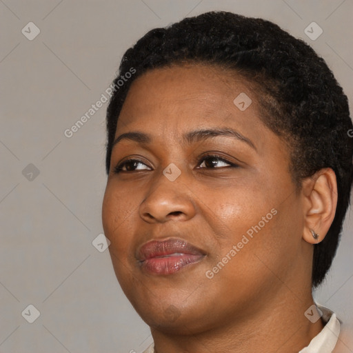 Joyful black young-adult female with short  brown hair and brown eyes