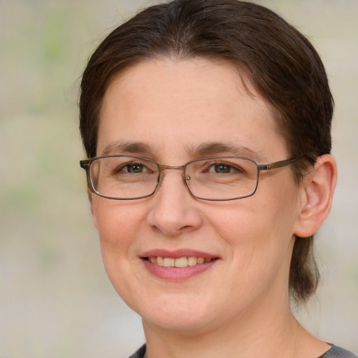 Joyful white adult female with medium  brown hair and blue eyes