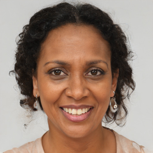 Joyful black adult female with medium  brown hair and brown eyes