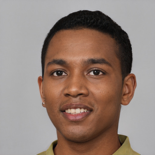Joyful black young-adult male with short  black hair and brown eyes