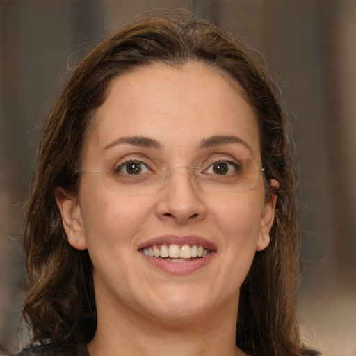 Joyful white young-adult female with long  brown hair and green eyes