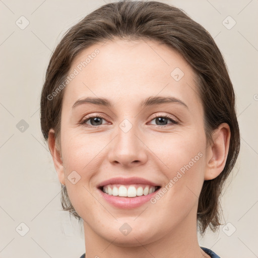 Joyful white young-adult female with medium  brown hair and grey eyes