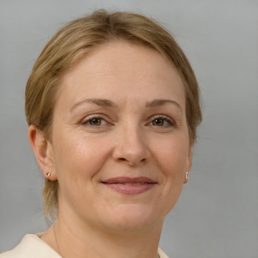 Joyful white adult female with medium  brown hair and brown eyes