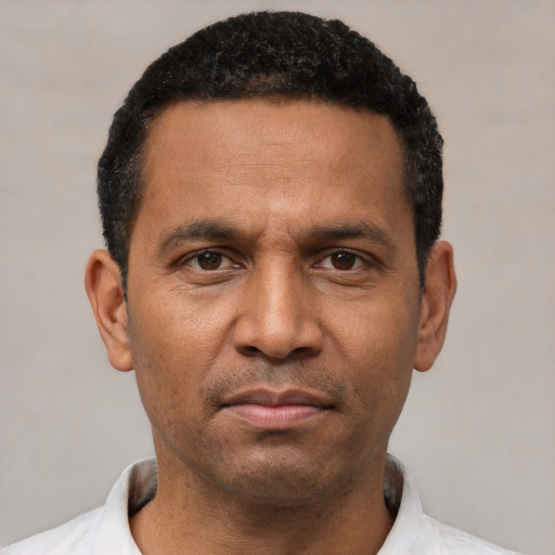 Neutral latino adult male with short  black hair and brown eyes