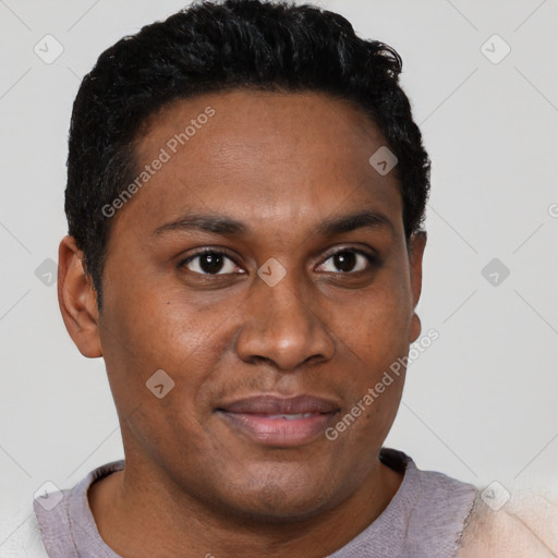 Joyful black adult male with short  brown hair and brown eyes