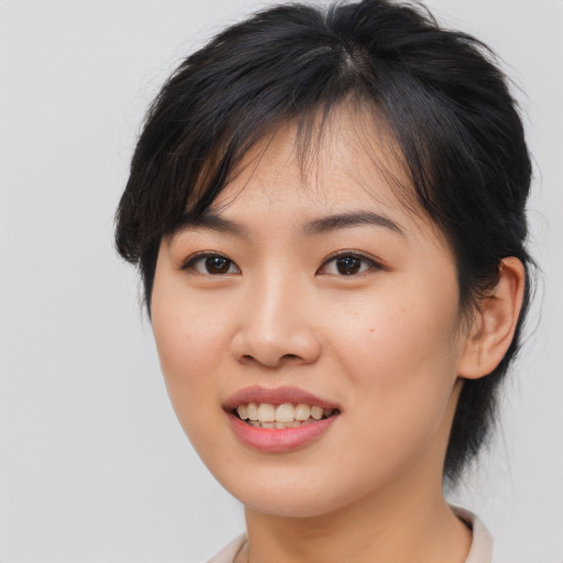 Joyful asian young-adult female with medium  brown hair and brown eyes