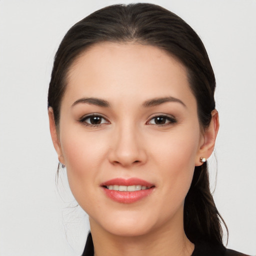 Joyful white young-adult female with long  brown hair and brown eyes