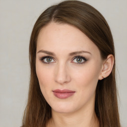 Joyful white young-adult female with long  brown hair and green eyes