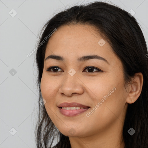 Joyful asian young-adult female with long  brown hair and brown eyes